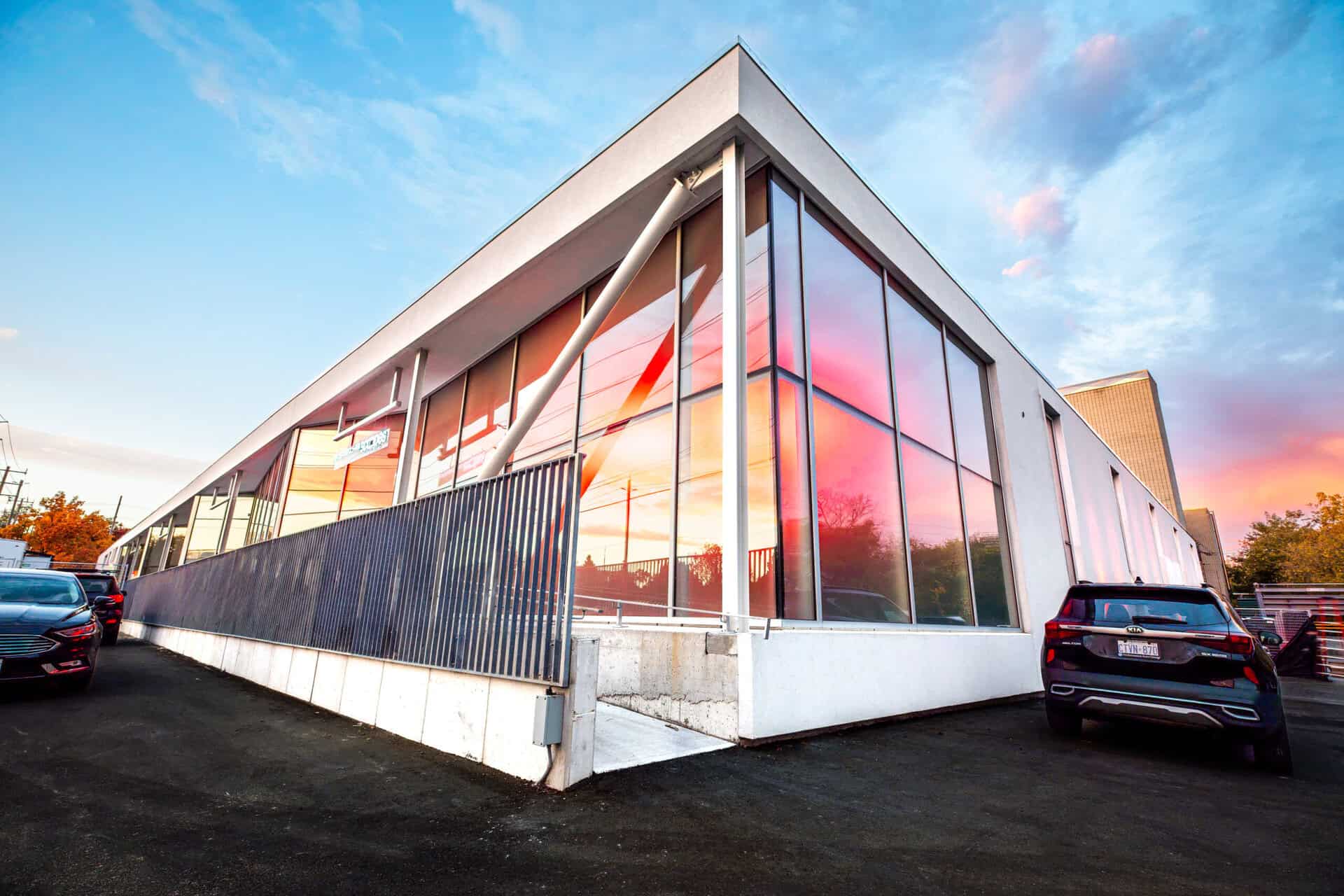 V2R Group modern office building with glass facade and sleek design.