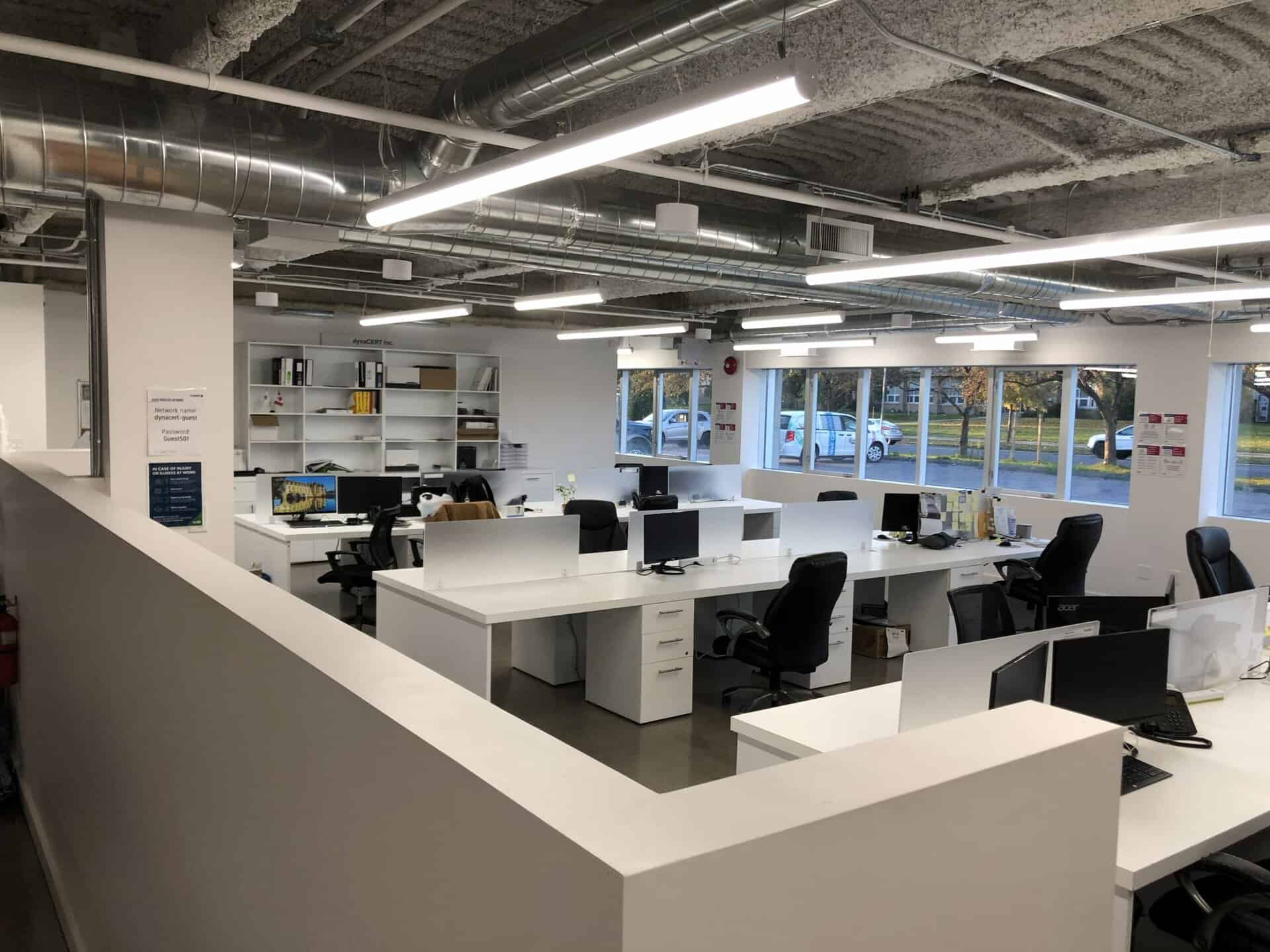 Office workspace with multiple desks and chairs at DynaCERT.